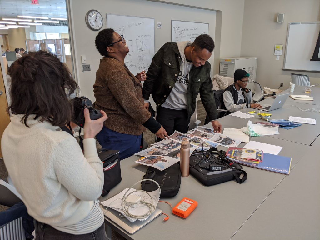 Fellows sift through photos for collaborative arts and humanities zine