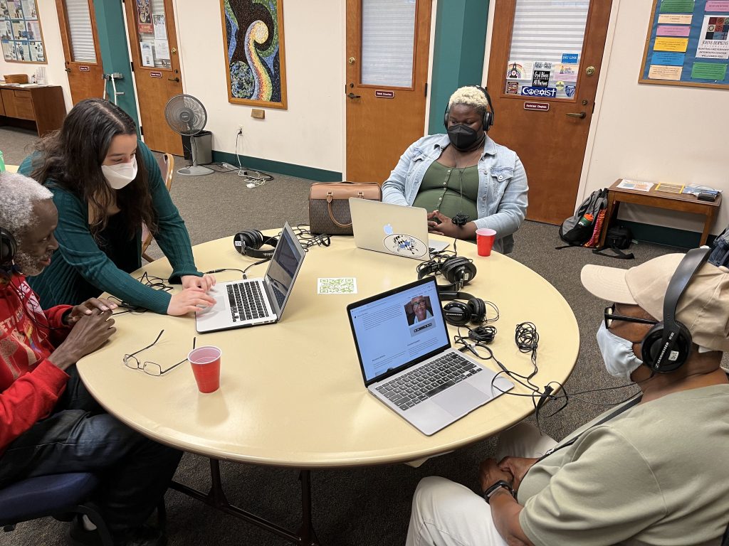 people sitting around a table at computers