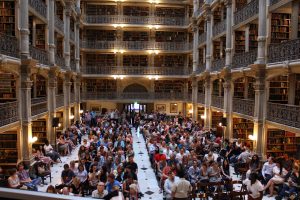 a seated audience in the Peabody Library
