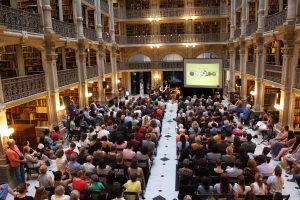 audience watching a performance in the Peabody Library