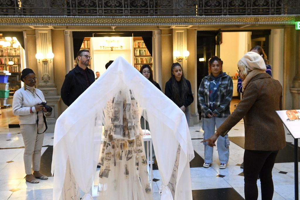 people looking at a sculpture