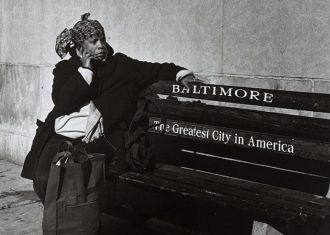 photo of a woman sitting on a baltimore bench