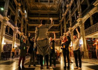 people with their fists up in the peabody library